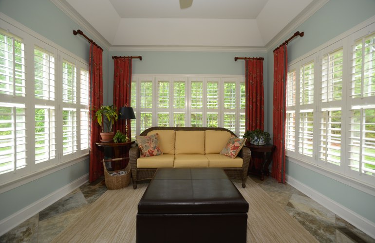 Southern California sunroom with white window shutters.